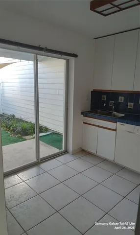 a kitchen with a sink and a large window