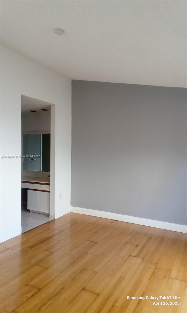 13764 Southwest 149th Cir Lane, Unit 1 Miami, FL 33186 - Photo 15 of 16 a view of empty room with wooden floor