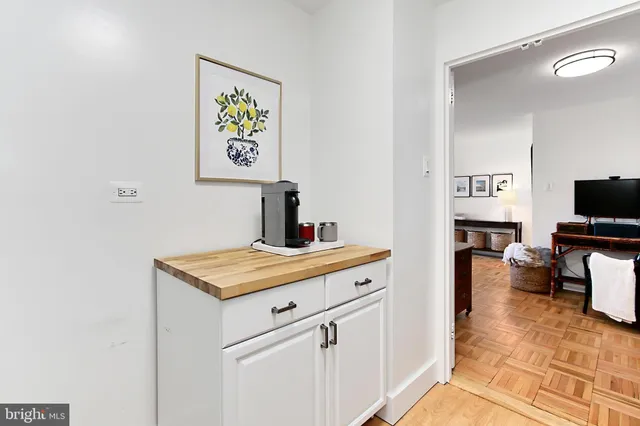 a view of kitchen with cabinets and flat screen tv