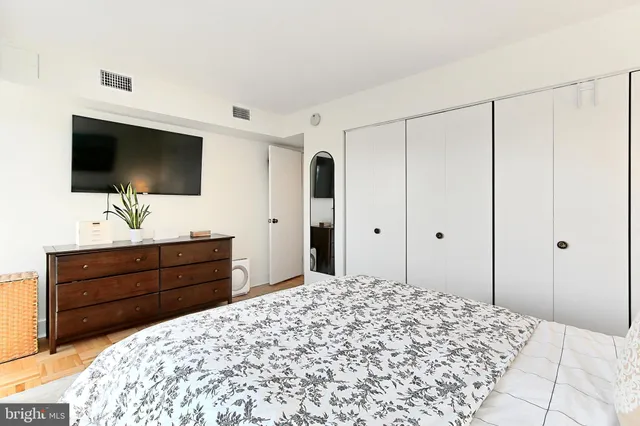 a bed room with a bed and a flat screen tv