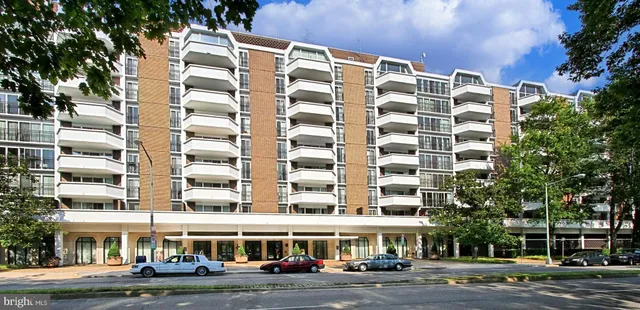 a view of a patio with a table and chairs under an umbrella