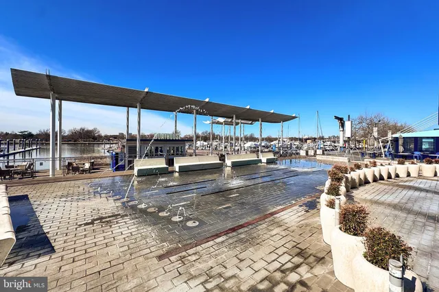 a view of a patio with chairs and umbrellas