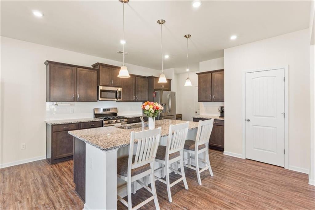 401 Larry Lane Adairsville, GA 30103 - Photo 11 of 41 a kitchen with stainless steel appliances a sink stove and refrigerator