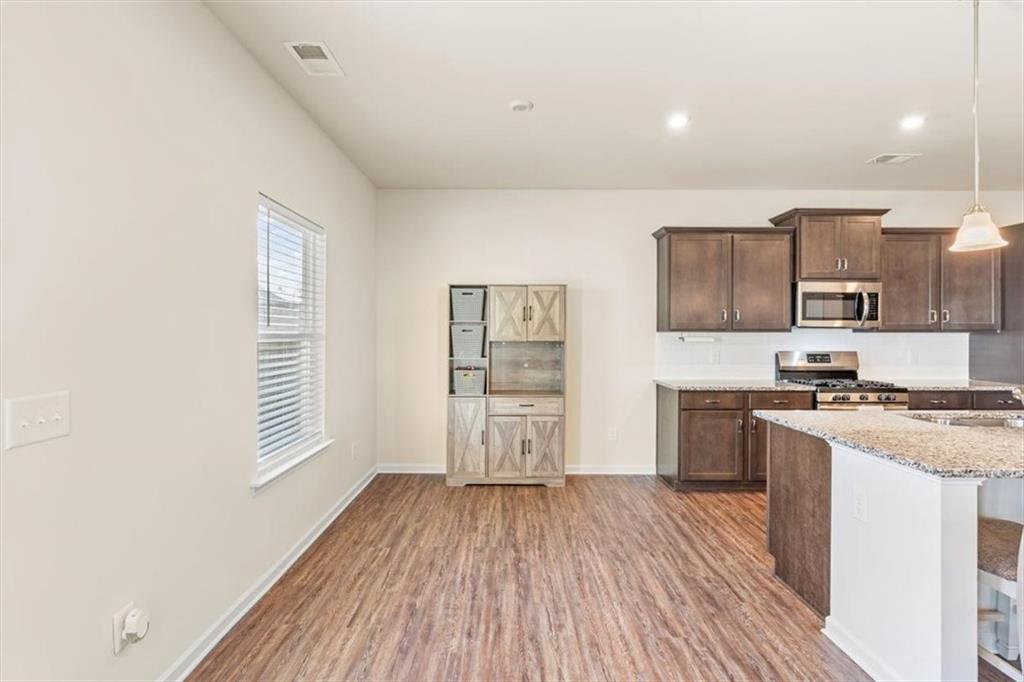 401 Larry Lane Adairsville, GA 30103 - Photo 12 of 41 a kitchen with stainless steel appliances granite countertop a stove a sink and a refrigerator