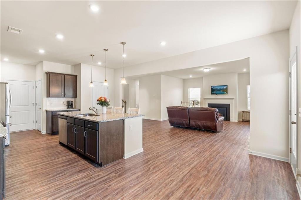 401 Larry Lane Adairsville, GA 30103 - Photo 13 of 41 a large kitchen with stainless steel appliances a large counter top a stove and a wooden floors
