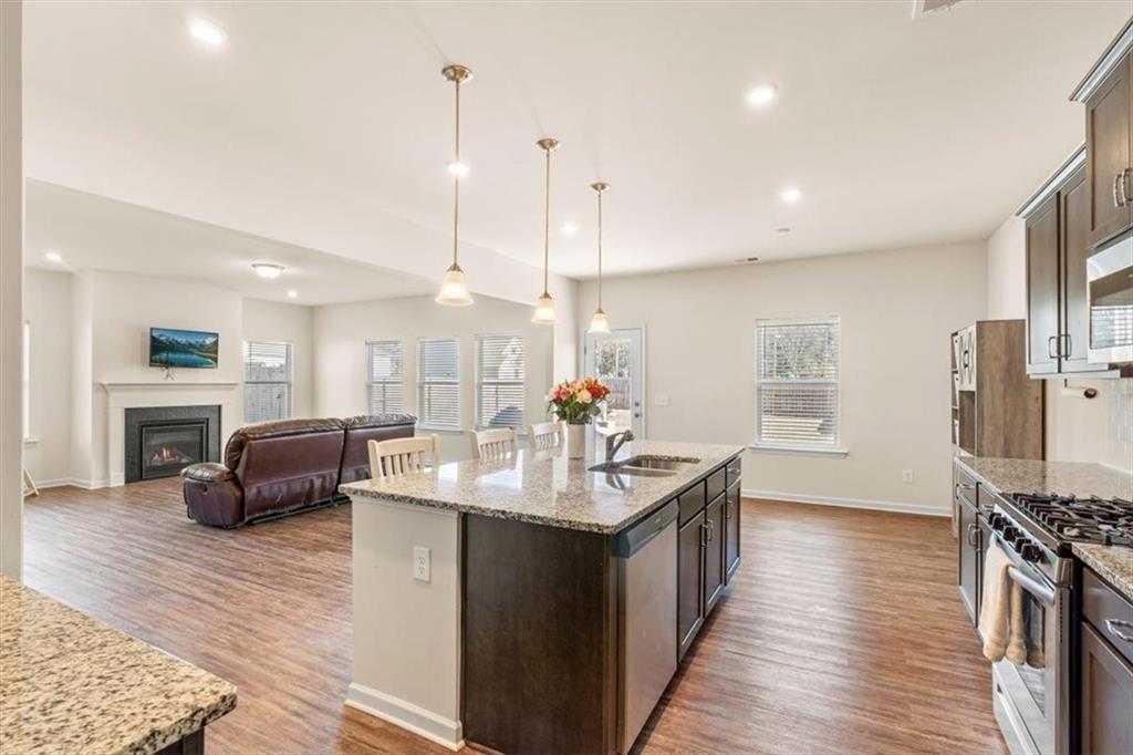 401 Larry Lane Adairsville, GA 30103 - Photo 14 of 41 a kitchen with stainless steel appliances granite countertop a sink stove and wooden floor
