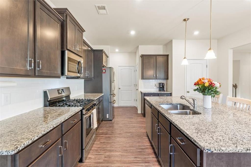 401 Larry Lane Adairsville, GA 30103 - Photo 15 of 41 a kitchen with granite countertop kitchen island stainless steel appliances a sink stove and cabinets