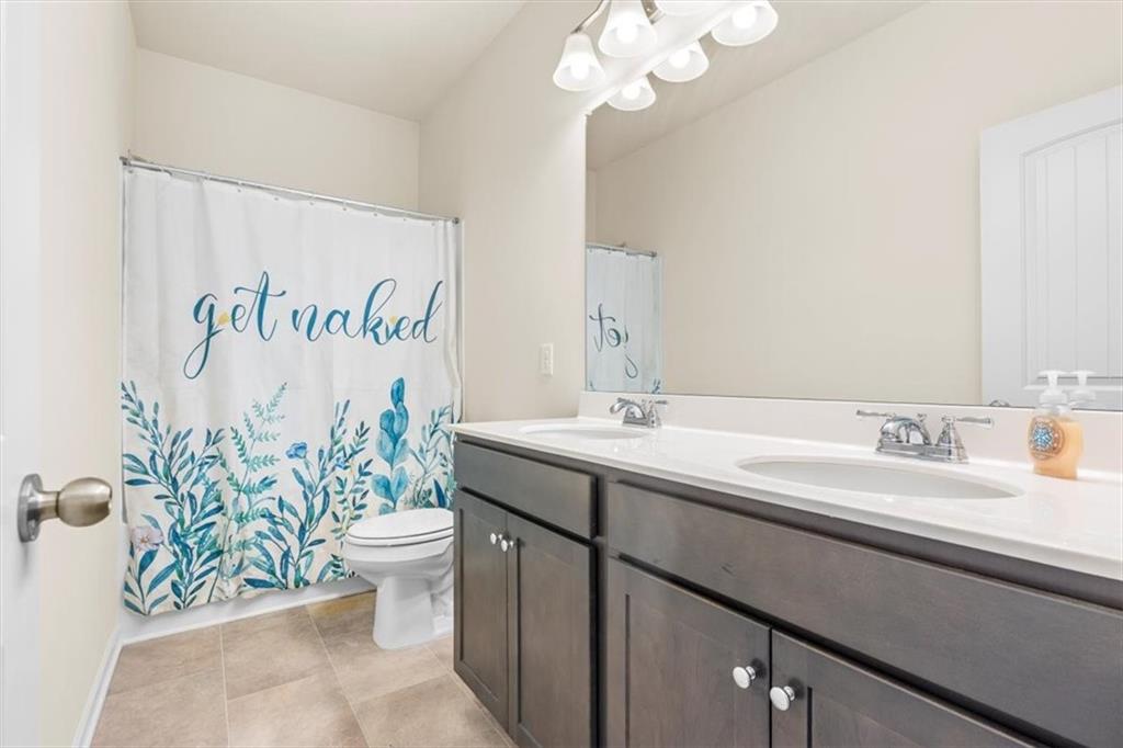 401 Larry Lane Adairsville, GA 30103 - Photo 20 of 41 a bathroom with a sink a toilet and a mirror