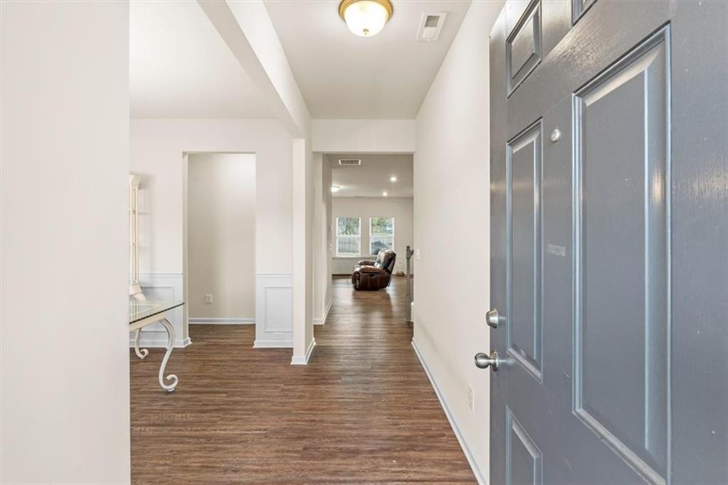 401 Larry Lane Adairsville, GA 30103 - Photo 4 of 41 a view of a hallway with wooden floor and staircase