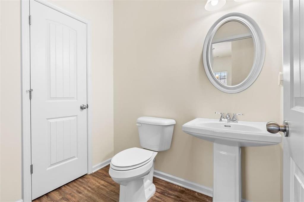 401 Larry Lane Adairsville, GA 30103 - Photo 6 of 41 a bathroom with a toilet a sink and a mirror