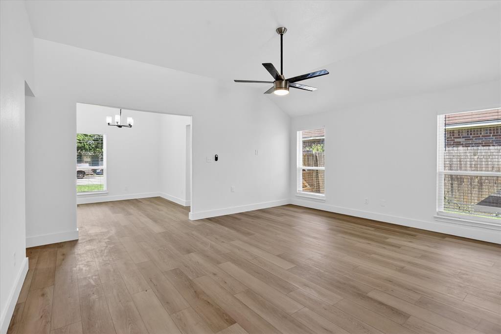 6021 Hartman Road Forest Hill, TX 76119 - Photo 5 of 27 a view of empty room with wooden floor and ceiling fan