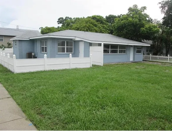 a front view of a house with a yard and porch