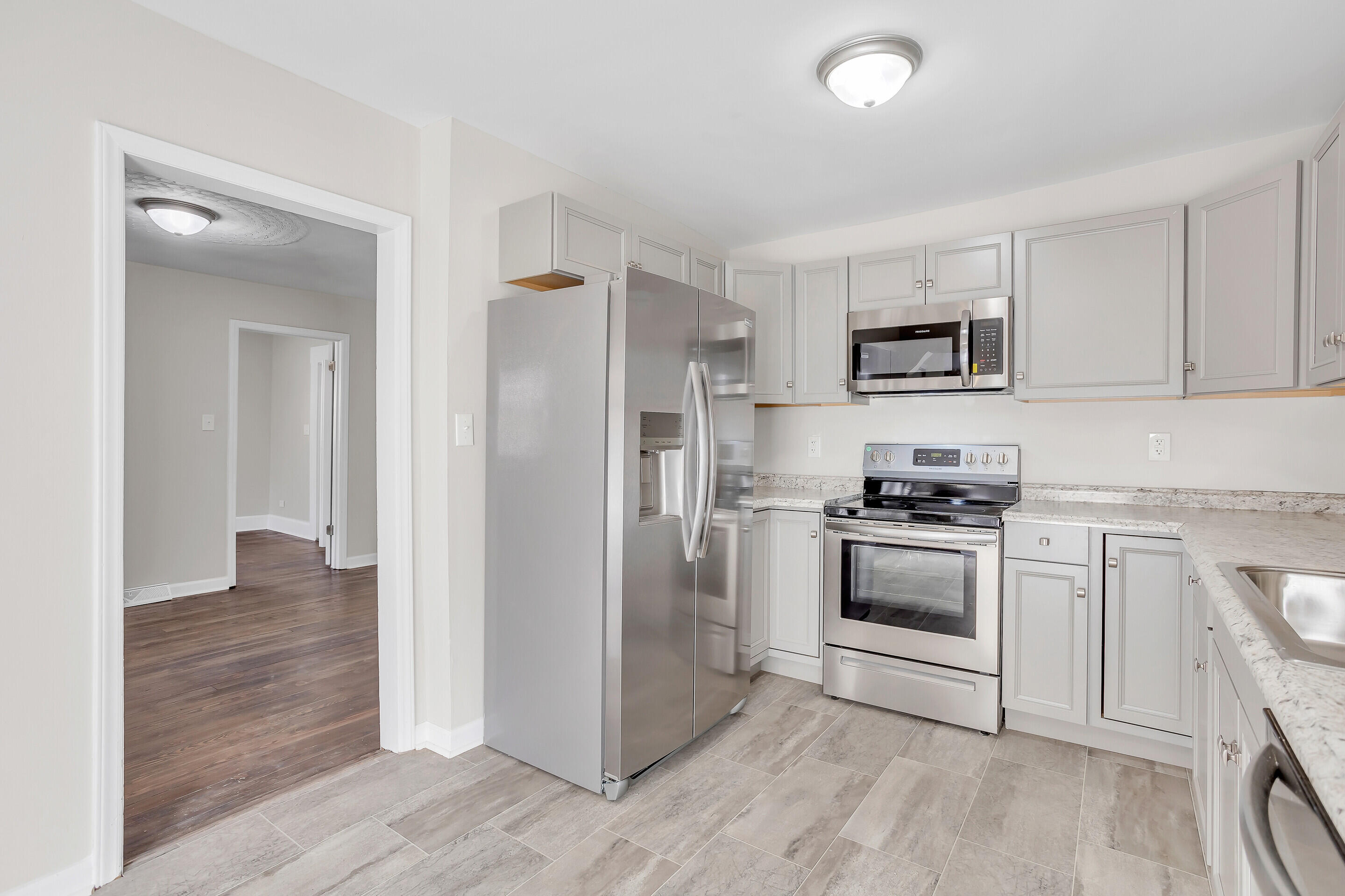 3757 Rutrough Road Southeast Roanoke, VA 24014 - Photo 11 of 42 a kitchen with white cabinets and stainless steel appliances