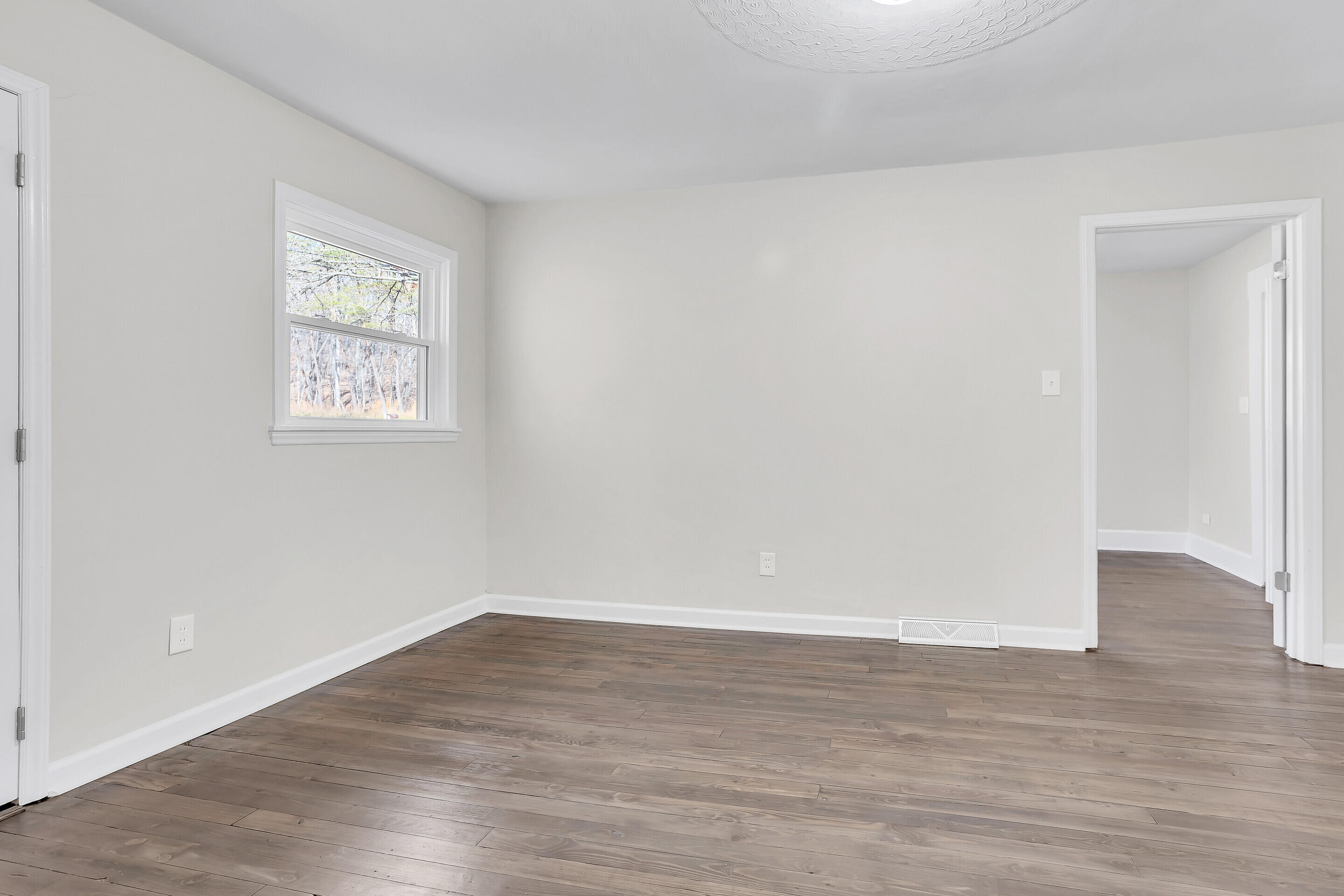3757 Rutrough Road Southeast Roanoke, VA 24014 - Photo 14 of 42 a view of an empty room with wooden floor and a window