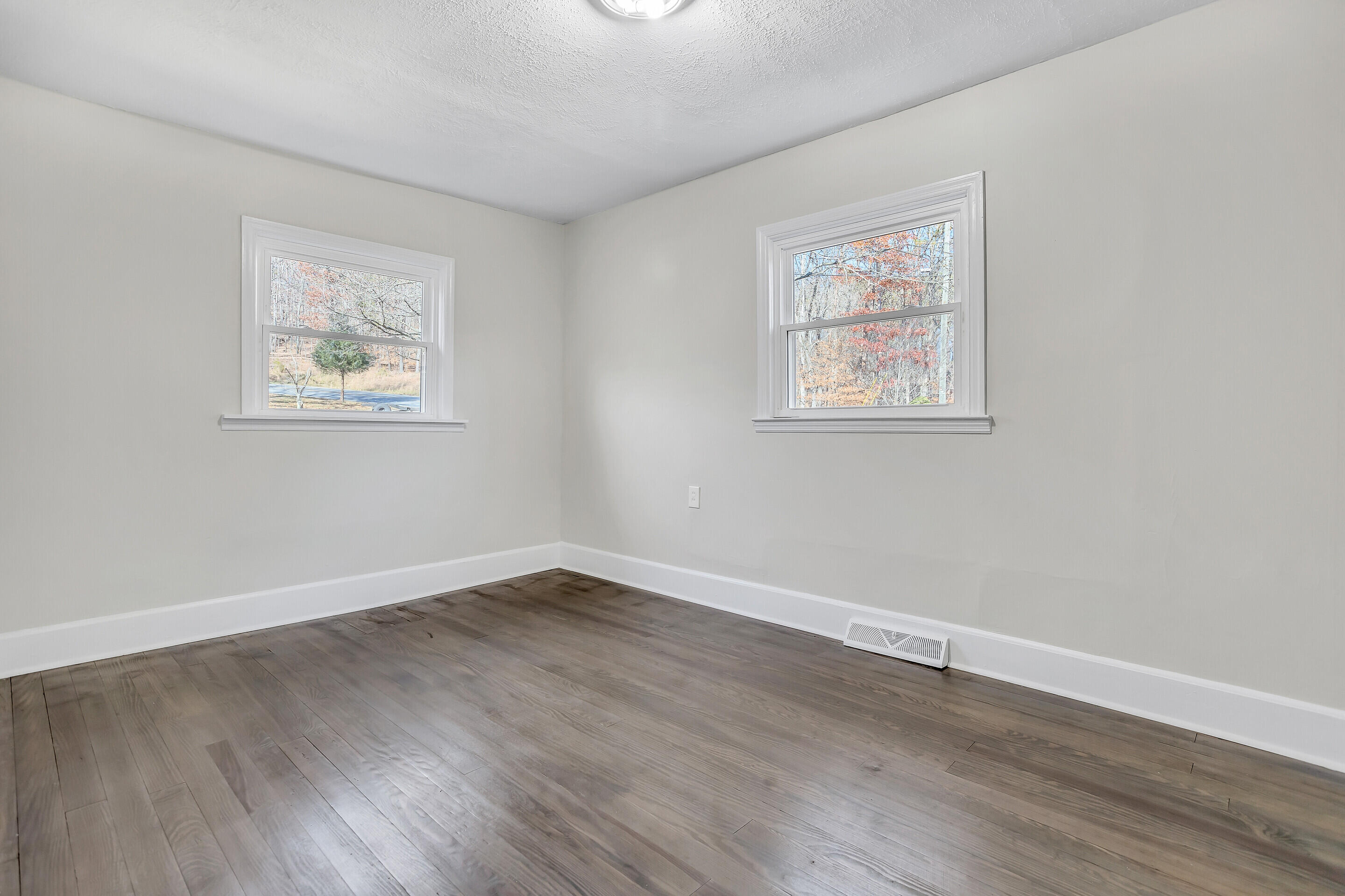 3757 Rutrough Road Southeast Roanoke, VA 24014 - Photo 17 of 42 a view of an empty room with wooden floor and a window