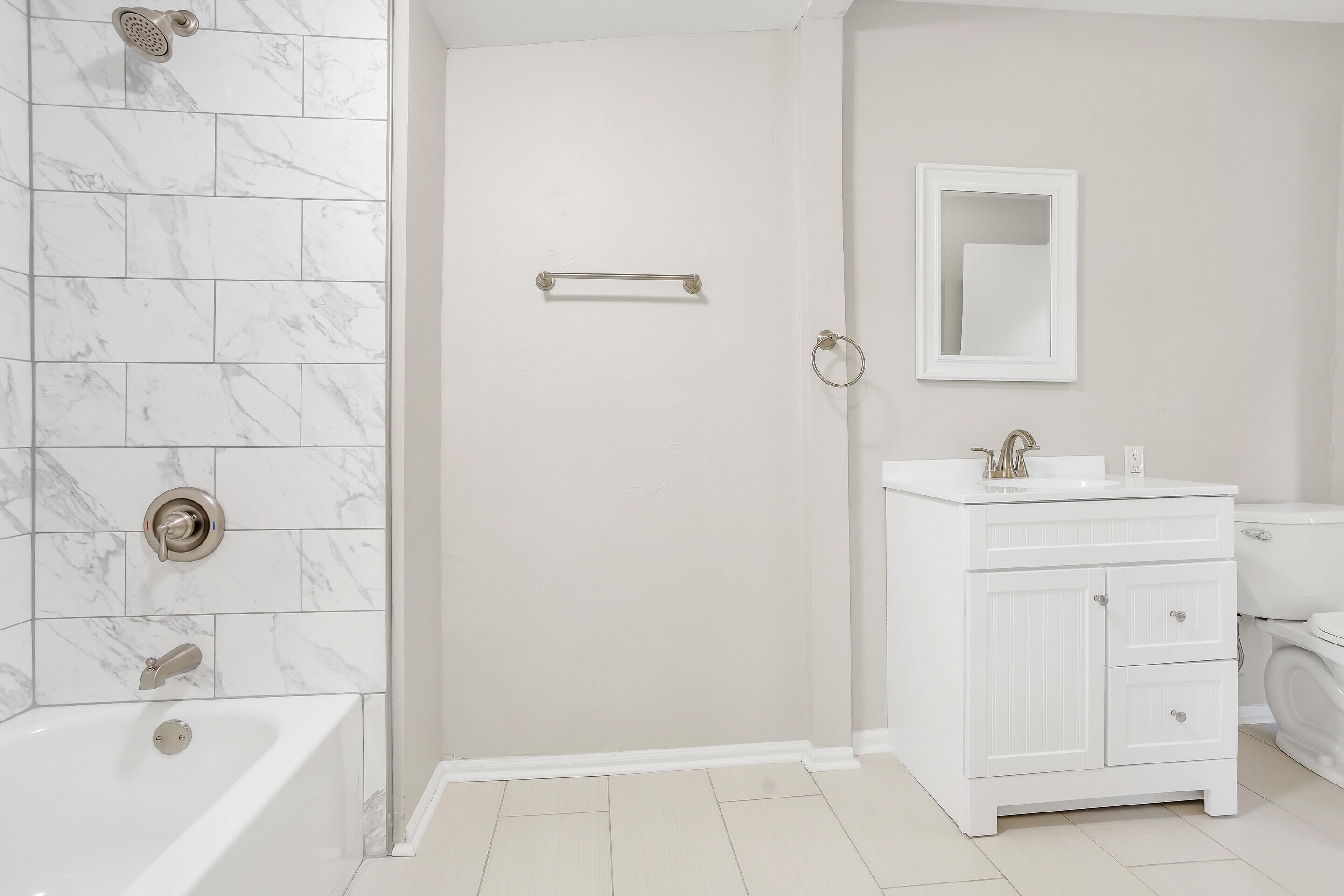 3757 Rutrough Road Southeast Roanoke, VA 24014 - Photo 22 of 42 a bathroom with a bathtub a sink a vanity and a window