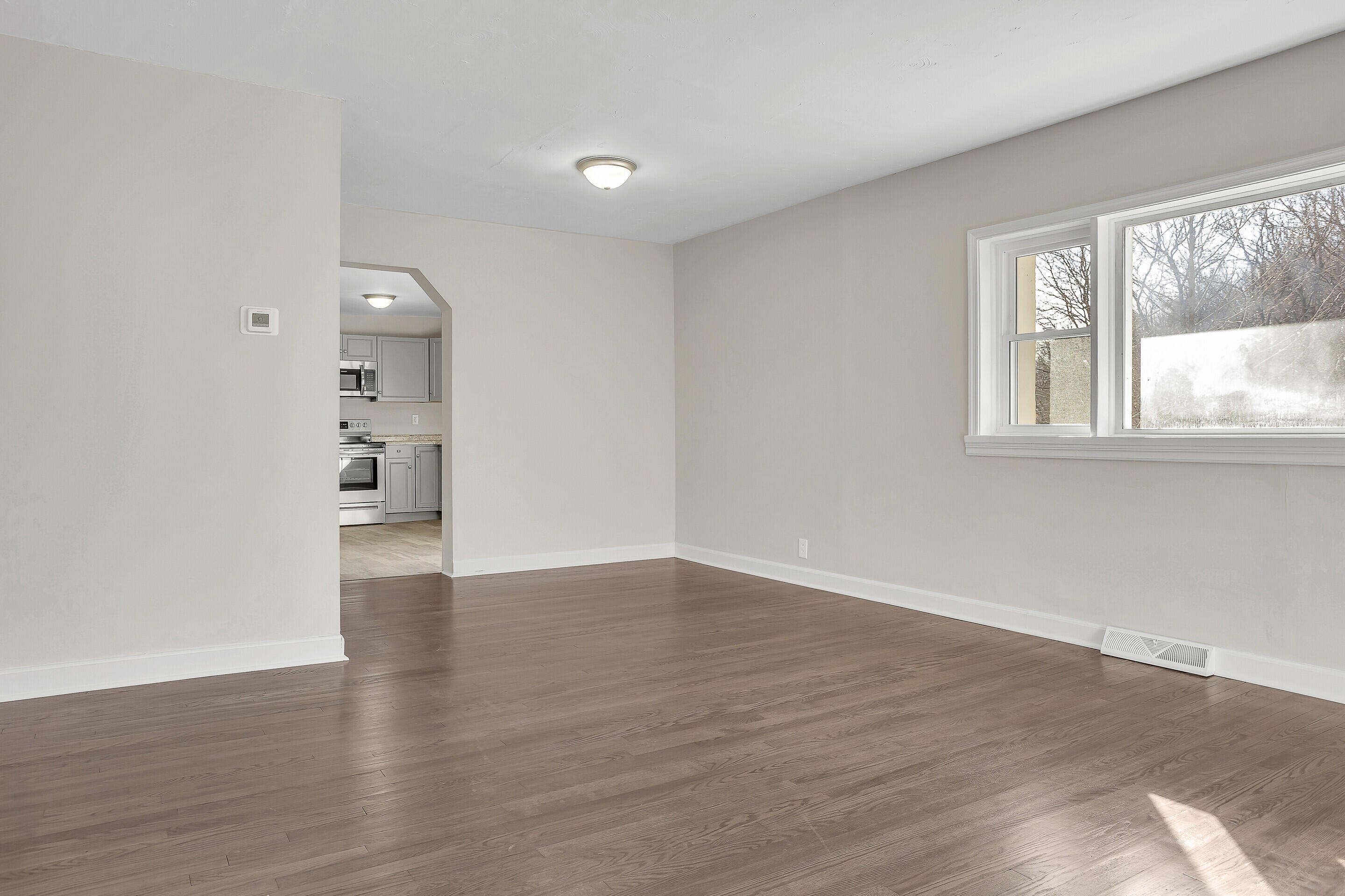 3757 Rutrough Road Southeast Roanoke, VA 24014 - Photo 7 of 42 a view of an empty room with wooden floor and a window