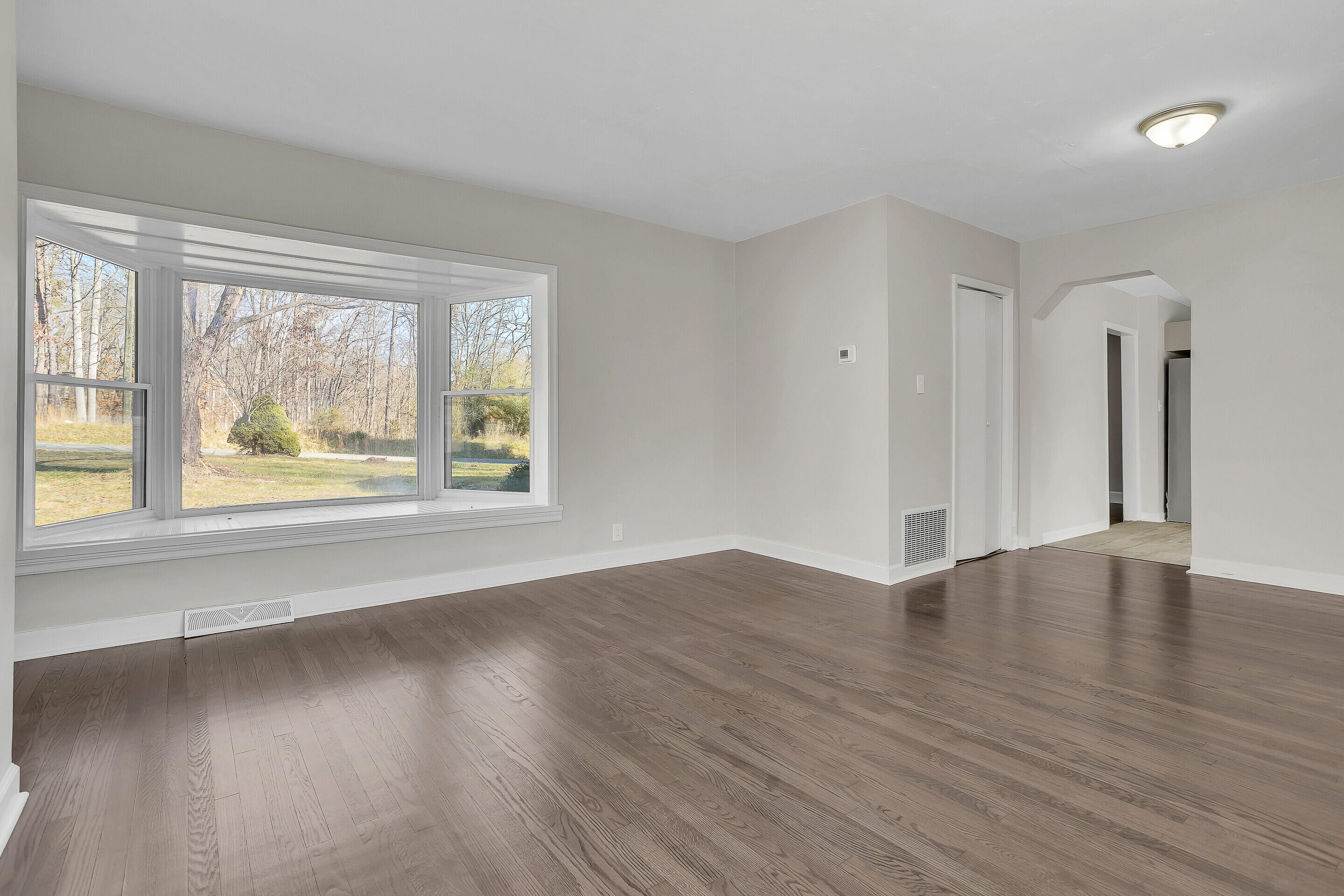 3757 Rutrough Road Southeast Roanoke, VA 24014 - Photo 8 of 42 an empty room with wooden floor and windows