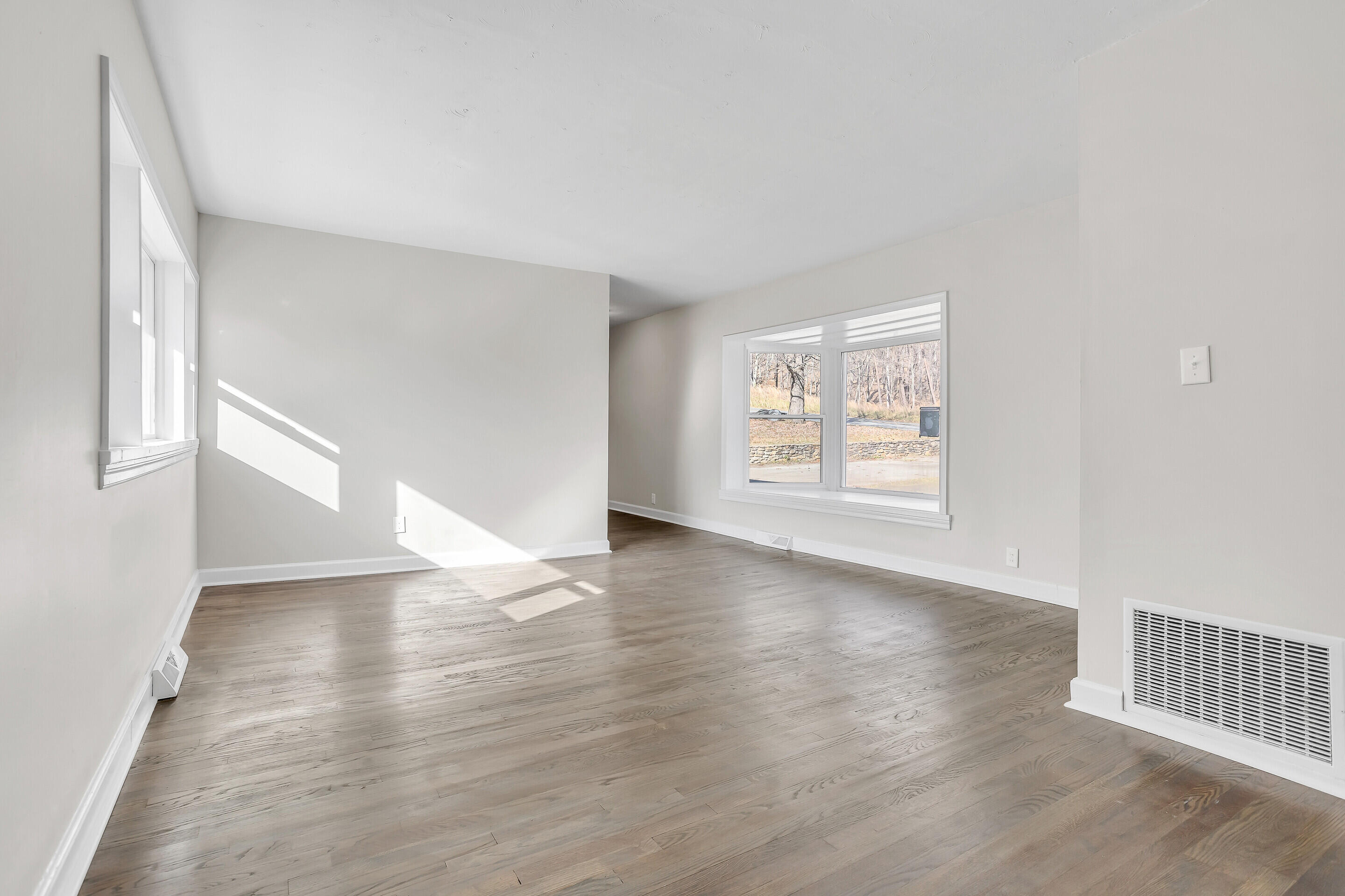 3757 Rutrough Road Southeast Roanoke, VA 24014 - Photo 9 of 42 an empty room with wooden floor and windows