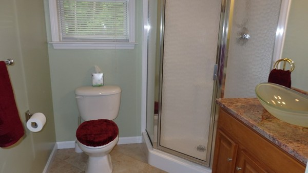 489 Market Hill Road Amherst, MA 01002 - Photo 17 of 27 a bathroom with a granite countertop toilet and a sink