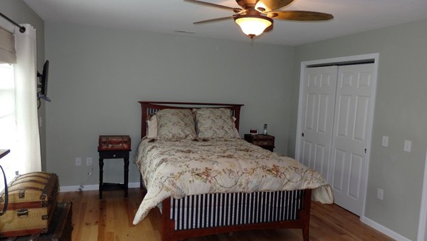 489 Market Hill Road Amherst, MA 01002 - Photo 18 of 27 a bedroom with a bed and a chandelier