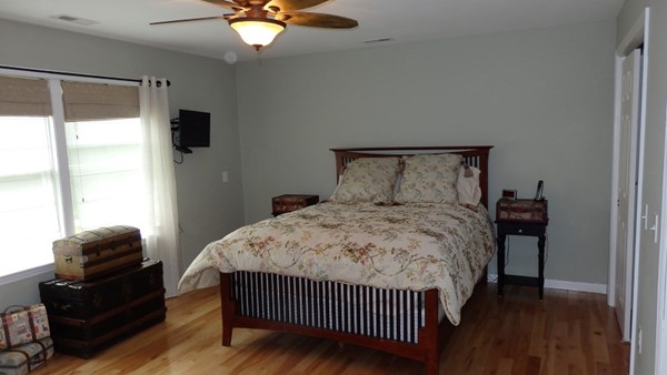 489 Market Hill Road Amherst, MA 01002 - Photo 19 of 27 a bedroom with a bed and wooden floor