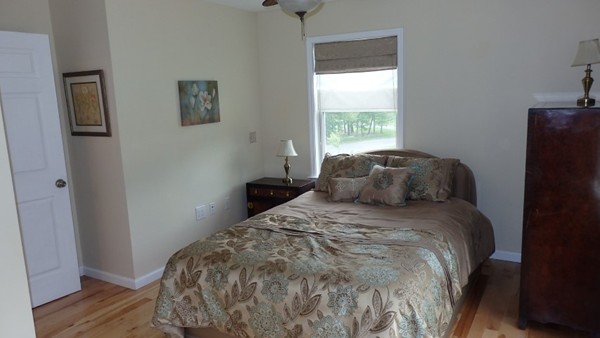 489 Market Hill Road Amherst, MA 01002 - Photo 22 of 27 a bed sitting in a bedroom next to a window