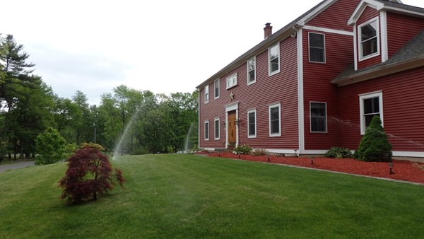 489 Market Hill Road Amherst, MA 01002 - Photo 4 of 27 a front view of a house with a garden and yard