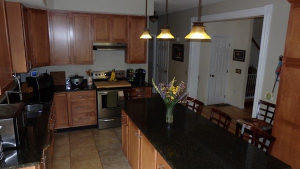 489 Market Hill Road Amherst, MA 01002 - Photo 5 of 27 a kitchen with refrigerator and cabinets