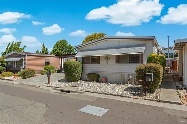 a view of a chair and tables in the patio