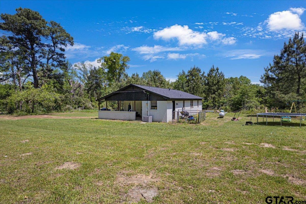 10638 County Road 384 Tyler, TX 75708 - Photo 21 of 33 a yellow house in middle of the green field