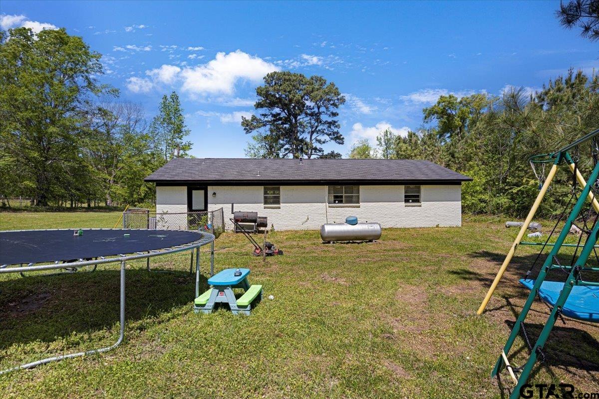 10638 County Road 384 Tyler, TX 75708 - Photo 23 of 33 a backyard of a house with table and chairs
