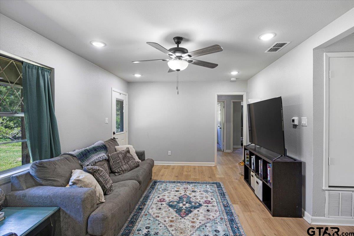 10638 County Road 384 Tyler, TX 75708 - Photo 10 of 33 a living room with furniture and a flat screen tv