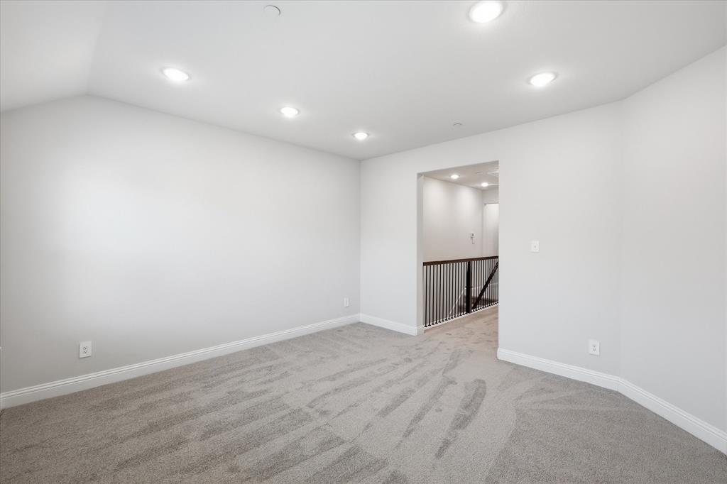 519 Sequoia Street Allen, TX 75002 - Photo 18 of 38 Carpeted room featuring recessed lighting, a neutral color palette, white baseboards, and an open entryway with a black iron baluster railing