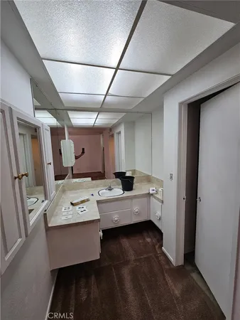 a room with furniture a flat screen tv and a window