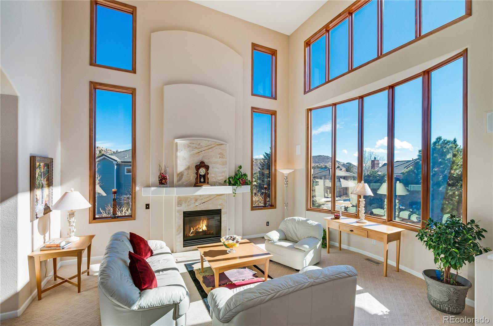 83 North Ranch Road Littleton, CO 80127 - Photo 6 of 35 a living room with furniture a fireplace and a large window