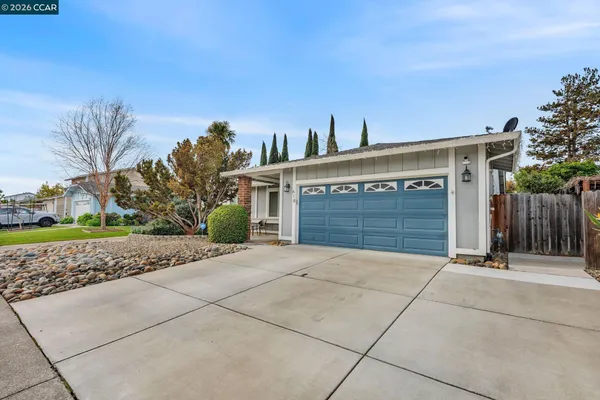 a view of a house with a yard and garage
