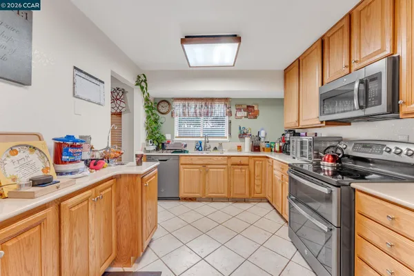a kitchen with a sink stove top oven and cabinets