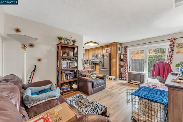 a living room with furniture and a book shelf