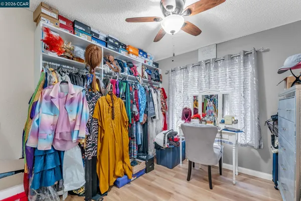a view of a room with furniture and clothes