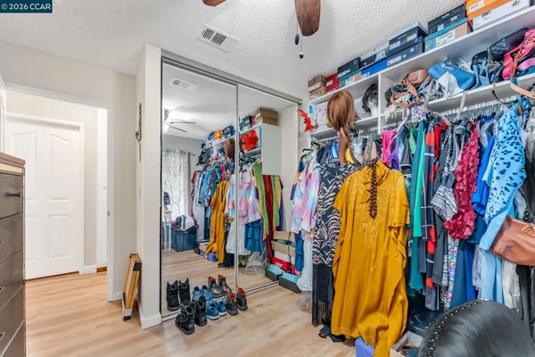 a view of walk in closet with clothes