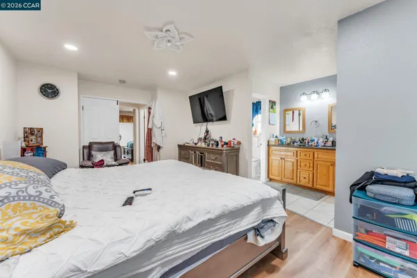 a room with a bed and a flat screen tv