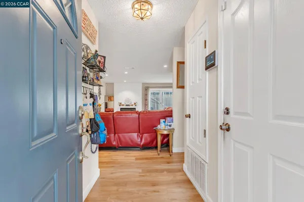 a view of living room kitchen and entryway