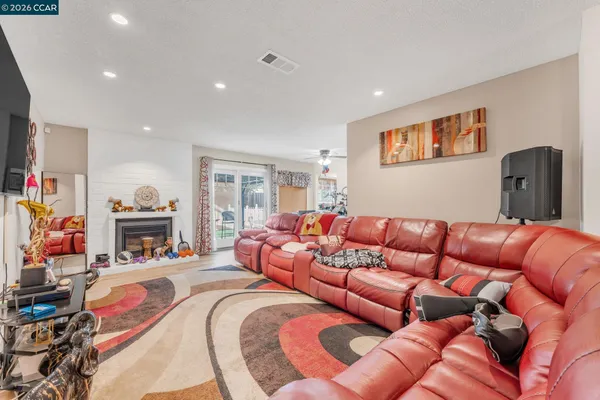 a living room with furniture a fireplace and a flat screen tv