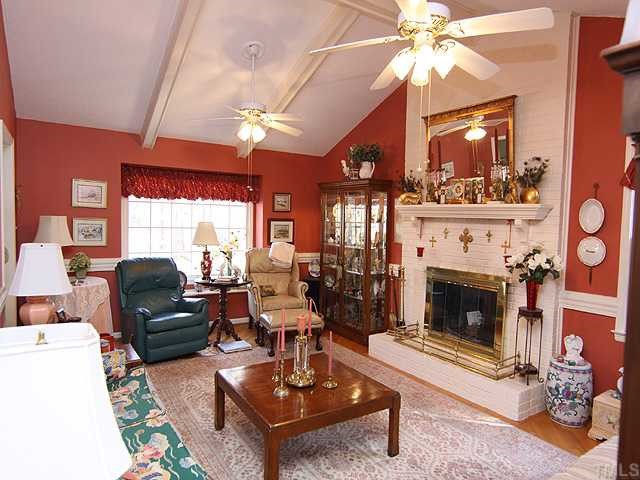 5516 Swiftbrook Circle Raleigh, NC 27606 - Photo 3 of 10 Spacious family room with beamed cathedraled ceiling and brick fireplace! Note the moulding and New hardwood floors throughout!