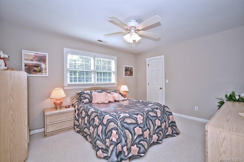 5406 Morgan Mill Road, Unit 2 Monroe, NC 28110 - Photo 12 of 23 a bedroom with a large bed and a chandelier