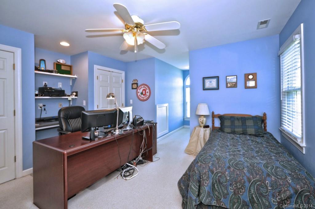 5406 Morgan Mill Road, Unit 2 Monroe, NC 28110 - Photo 13 of 23 a bedroom with a bed gym equipment and a chandelier