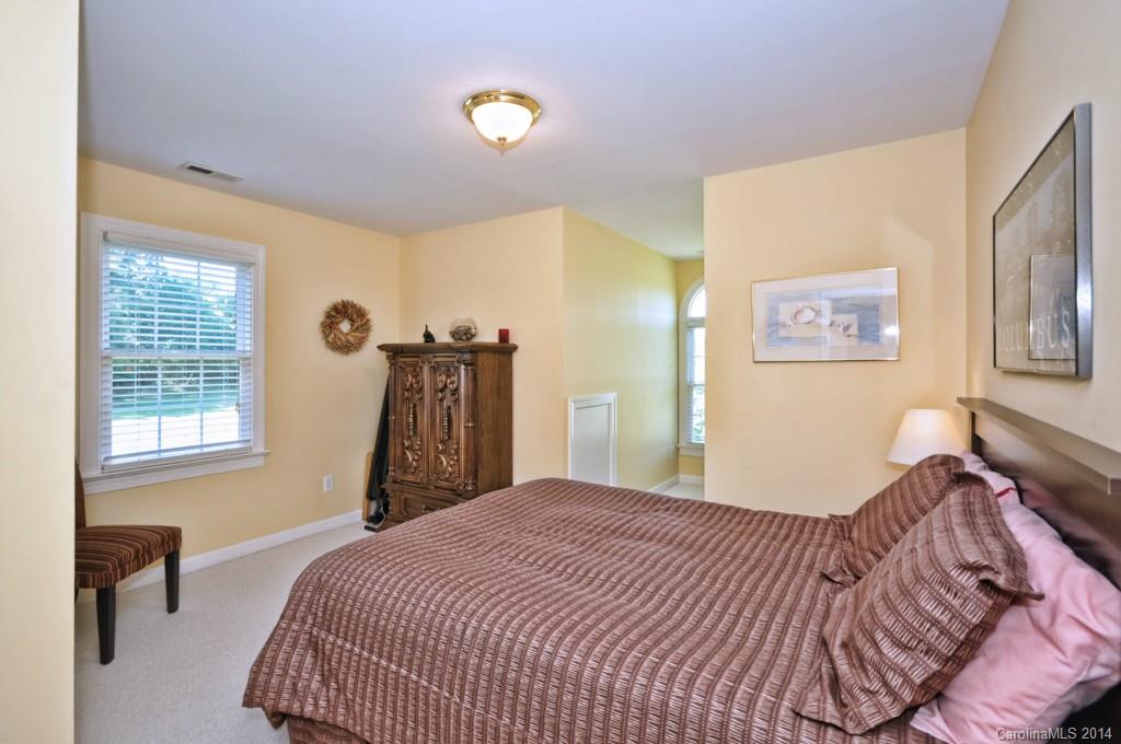 5406 Morgan Mill Road, Unit 2 Monroe, NC 28110 - Photo 14 of 23 a bedroom with a bed and a chandelier
