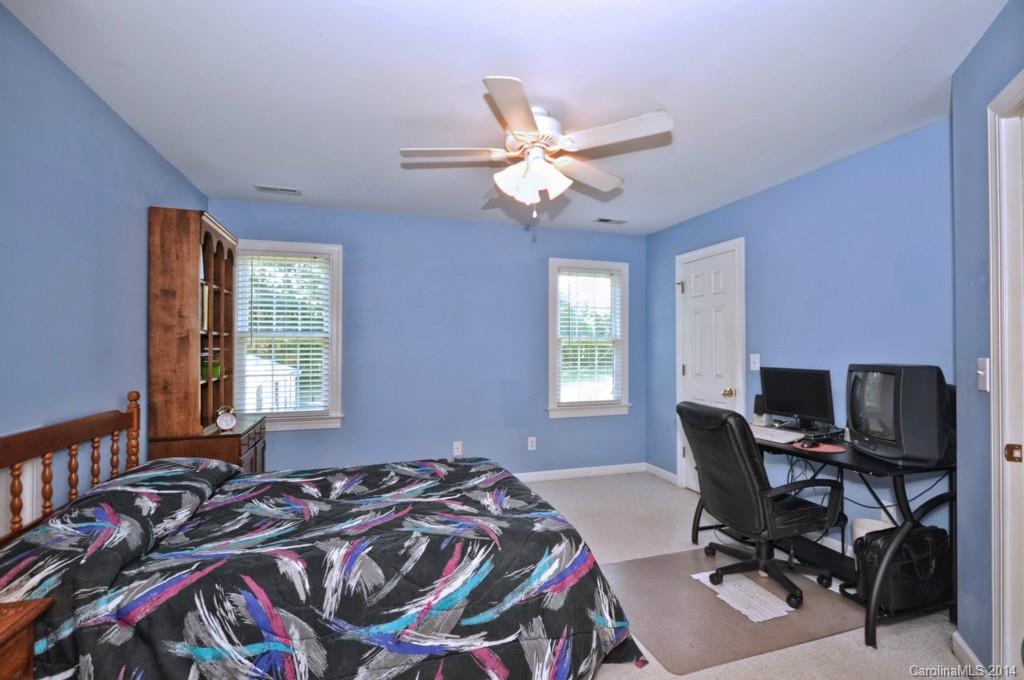 5406 Morgan Mill Road, Unit 2 Monroe, NC 28110 - Photo 15 of 23 a bed sitting in a bedroom next to a window