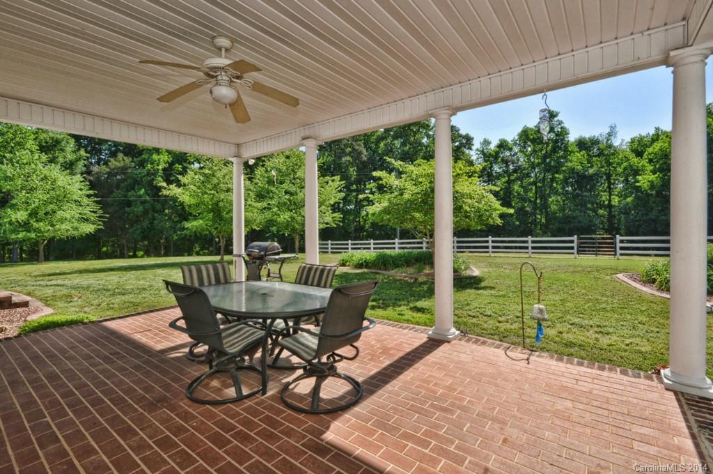 5406 Morgan Mill Road, Unit 2 Monroe, NC 28110 - Photo 16 of 23 a view of a patio with a table chairs and a yard